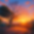 A tree stands in a sunset landscape with vibrant orange and purple hues. Sun rays illuminate the scene, creating a peaceful atmosphere.